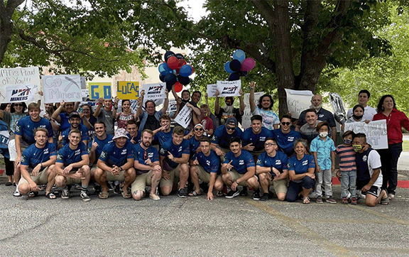 rugby team with supporters at the rally