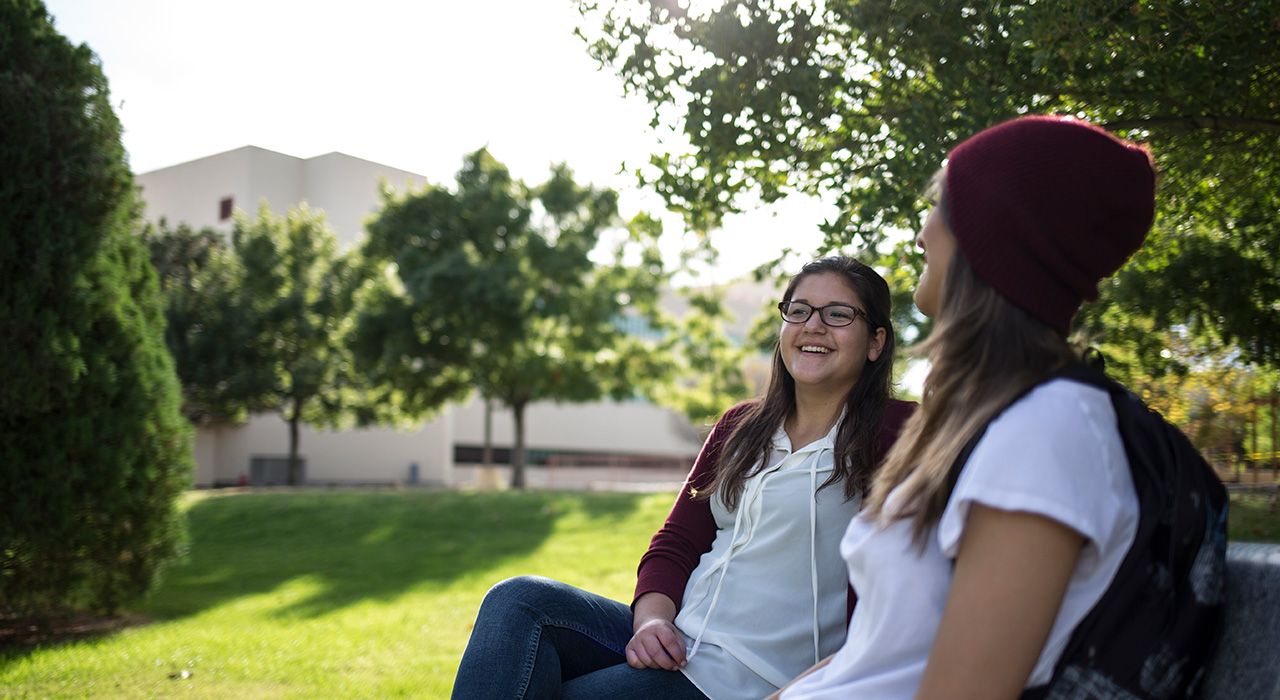 Two women talking on a bench